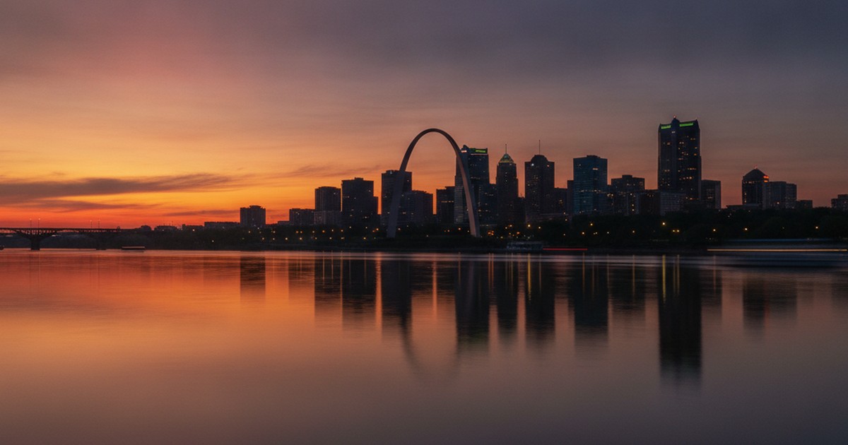 St. Louis skyline and Gateway Arch silhouetted at dusk
